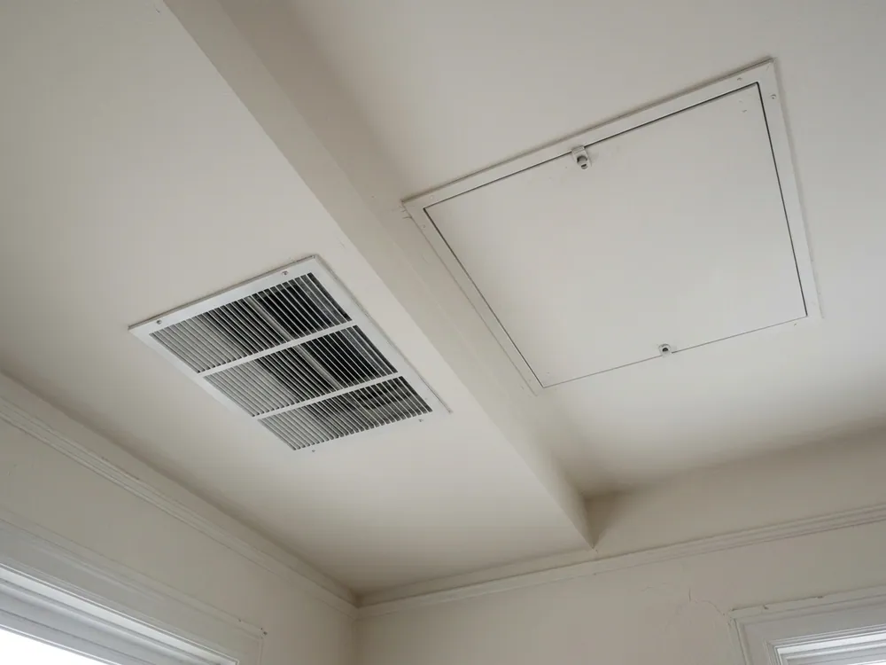 Return-air grille beside a hinged service-access panel.