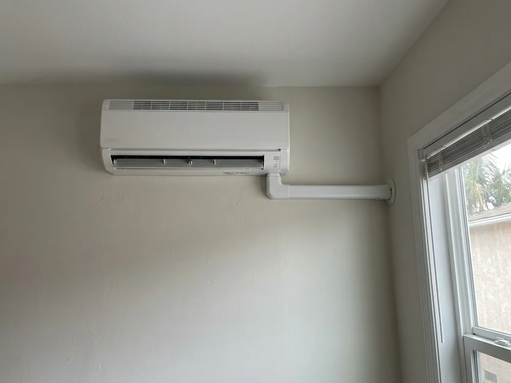 New indoor unit beside a finished protective line cover.